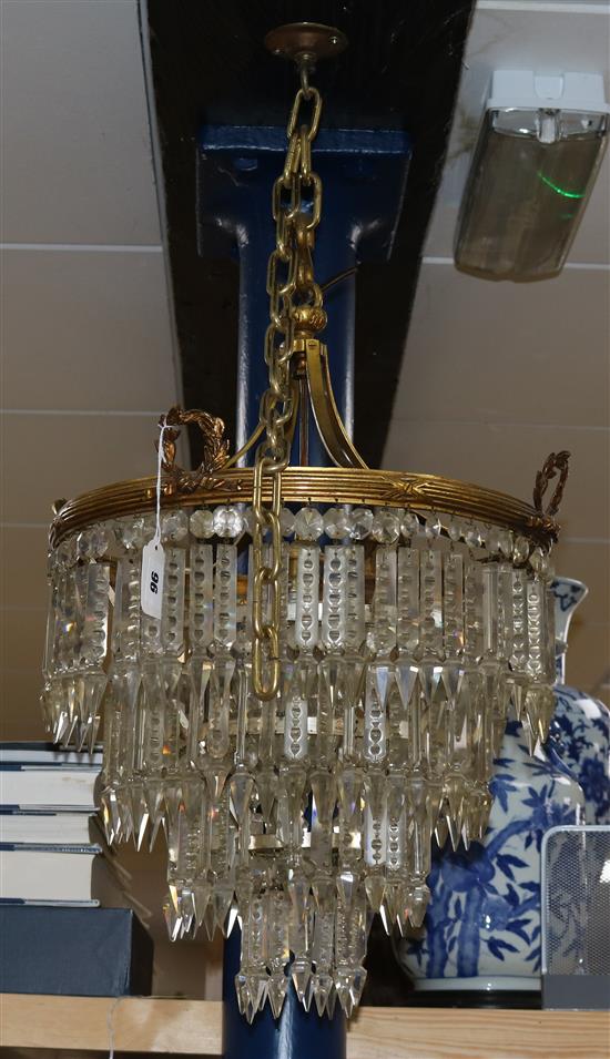 A gilt metal lustre four tier chandelier